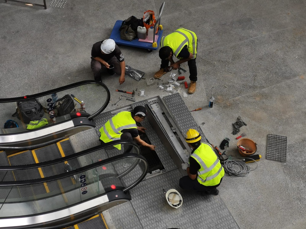 workers-fixing-escalator